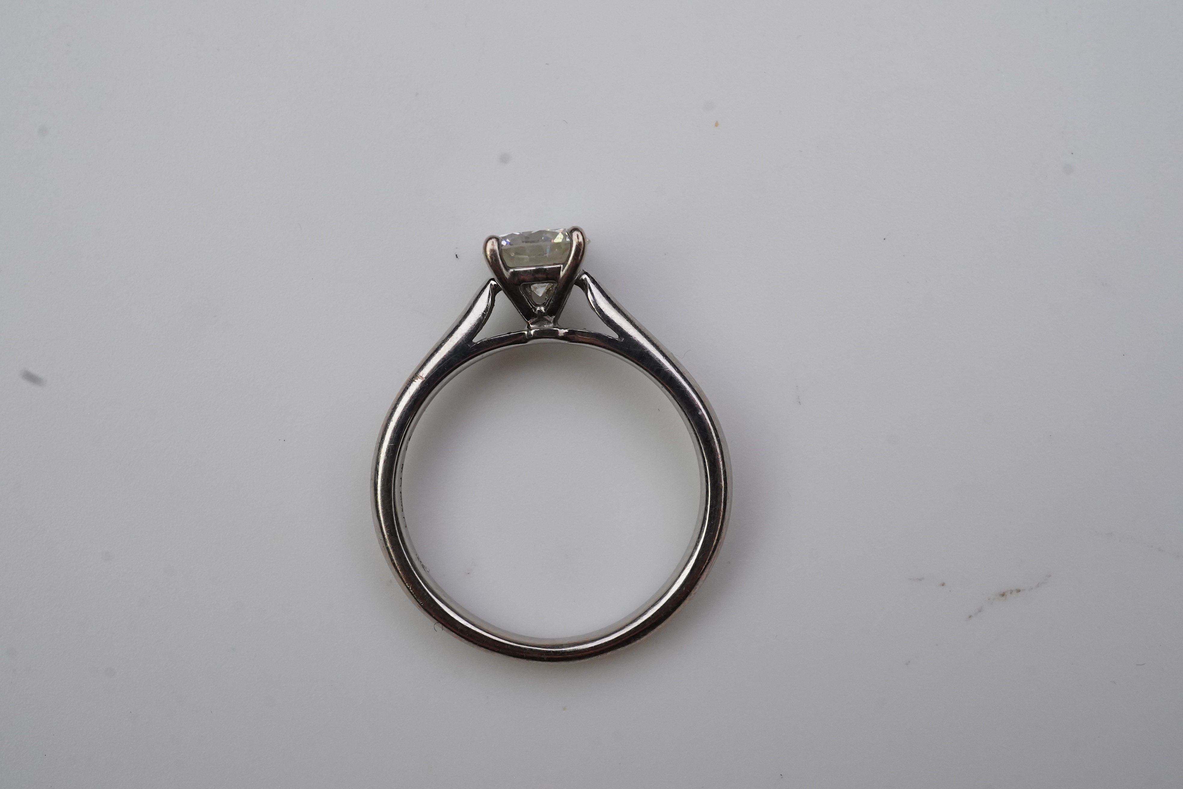 A solitaire diamond ring, claw-set with a brilliant-cut diamond weighing approximately 0.65 carats, mounted in 18ct white gold, size K1/2, British hallmarks, case. Condition - good